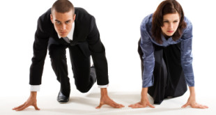 Young businesswoman and young businessman side-by-side in starting position and determined to win. Concepts: competition; corporate race; power struggle; battle of the sexes. Studio photography, isolated on white background.