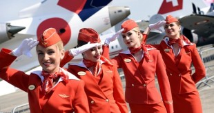 Cabin crew of the Russian airline Aeroflot salte as they walk past during the International Paris Airshow at Le Bourget on June 16, 2015.  AFP PHOTO /MIGUEL MEDINA        (Photo credit should read MIGUEL MEDINA/AFP/Getty Images)