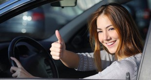 Happy Woman Inside A Car Gesturing Thumb Up