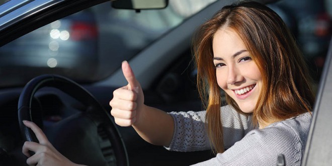 Happy Woman Inside A Car Gesturing Thumb Up